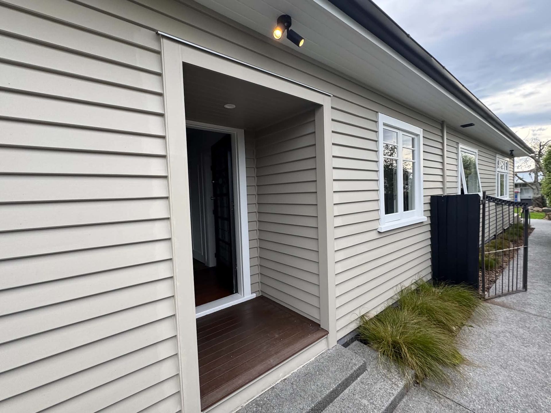 Cream weatherboard home with recessed entrance, repaint